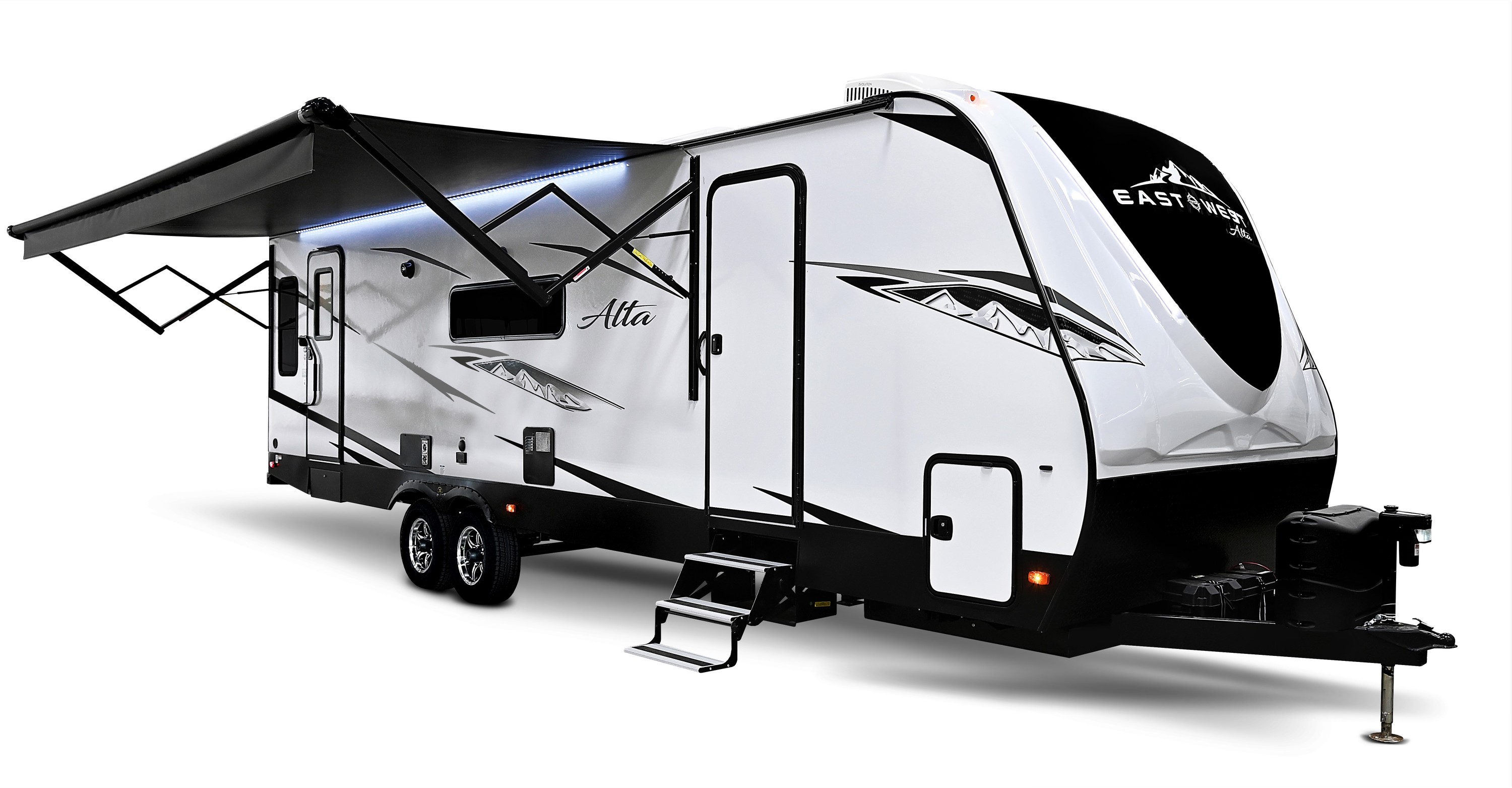 A white travel trailer with its awning up on a white background.